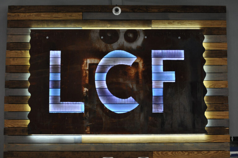 The lit LCF sign inside Life Changing Fitness