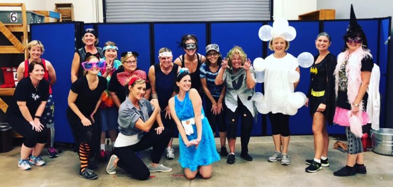 Members and trainers in costume for a Halloween class