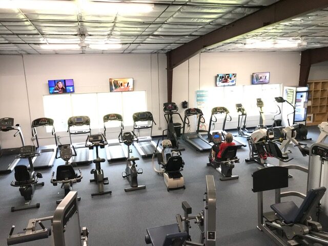 Rows of treadmills and bikes in the cardio area at Life Changing Fitness